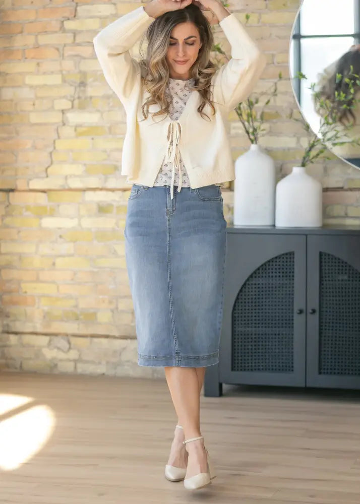Bryn light wash sustainable denim midi skirt in light blue with a classic straight cut and visible stitching details
