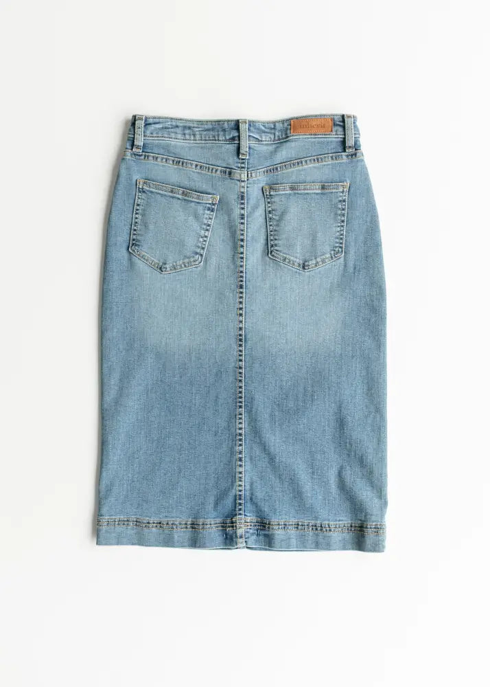 Back view of bryn light wash sustainable denim midi skirt with classic pockets and brown leather brand tag
