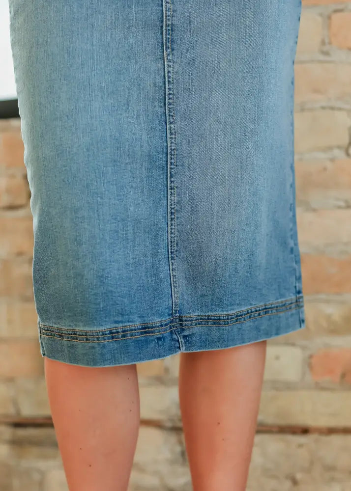 Bryn light wash sustainable denim midi skirt in classic light blue with a front seam and stitched hem