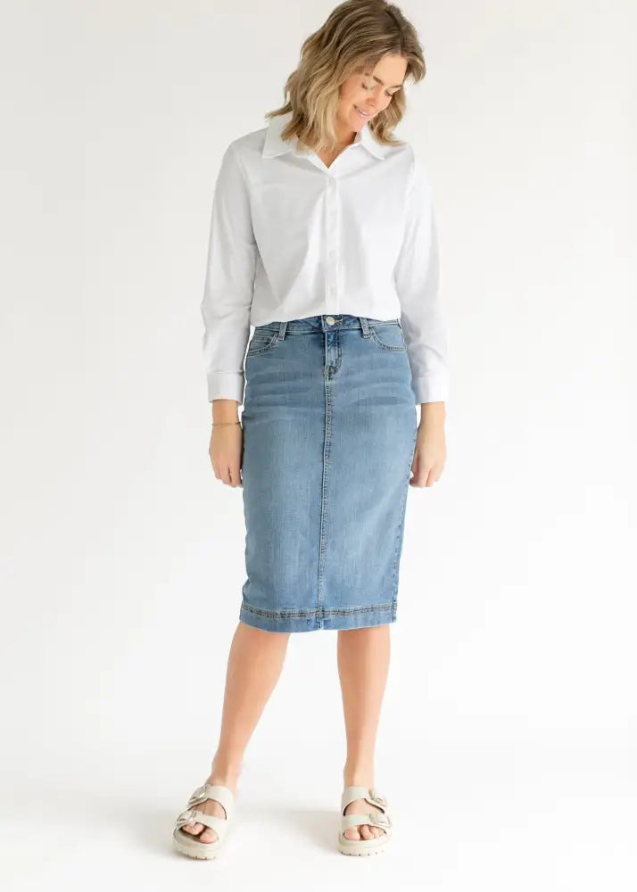Bryn light wash sustainable denim midi skirt with classic front button closure and belt loops in light wash denim