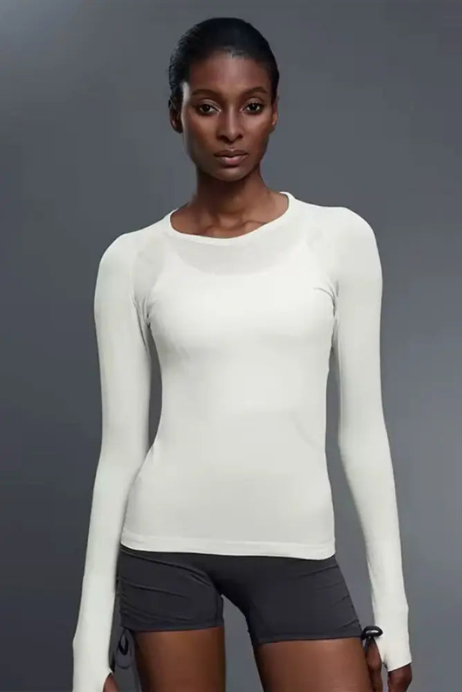 A sleek off-white seamless long-sleeved upf 30 baselayer top with ribbed cuffs from Btr Active for sun protection