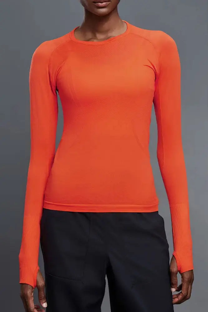 Bright orange btr active women’s seamless upf 30 sun protection baselayer with long sleeves and crew neckline