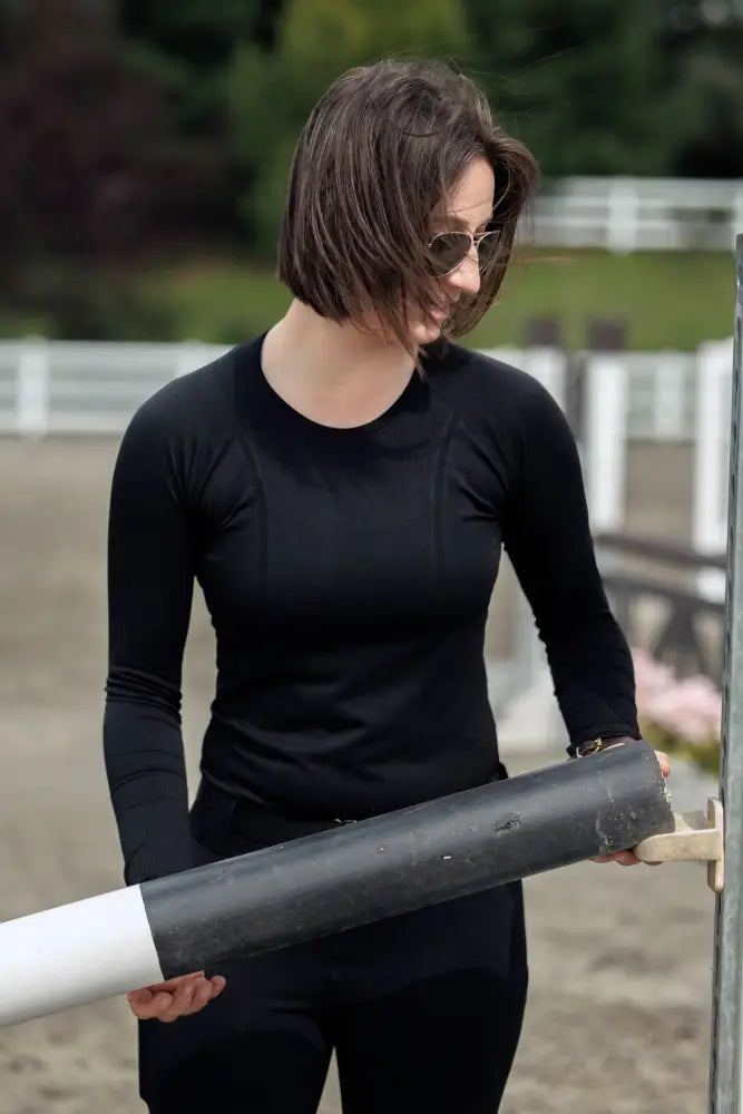 Black seamless long-sleeved athletic top with round neckline and upf 30 sun protection by Btr Active for women