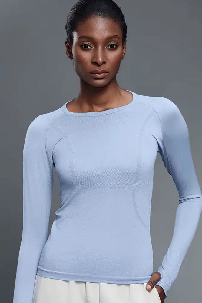 Light blue seamless long-sleeved athletic top with textured knit and UPF 30 sun protection baselayer for women