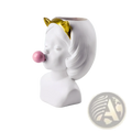 White ceramic vase shaped like a girl bust with gold cat ears blowing a pink bubblegum bubble