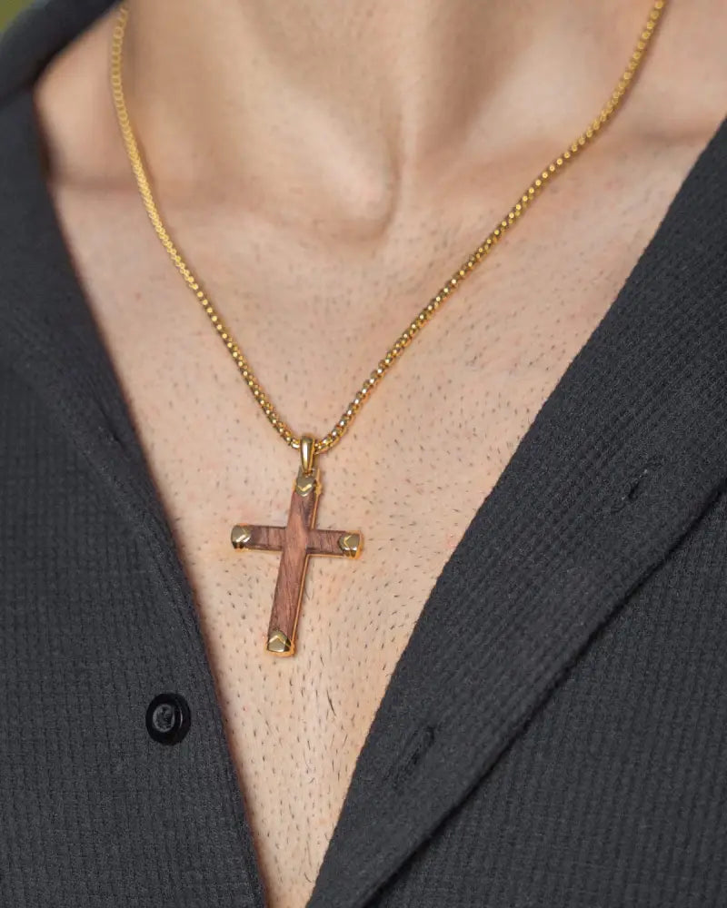 Gold-toned cross pendant with textured rose gold inlay on arms and tips in bubinga wood and gold stainless steel necklace