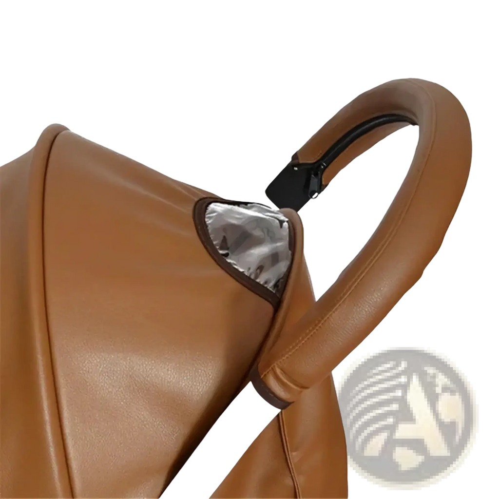 Brown leather bugaboo bee stroller handle cover with black clip and silver reflective panel visible from the back side