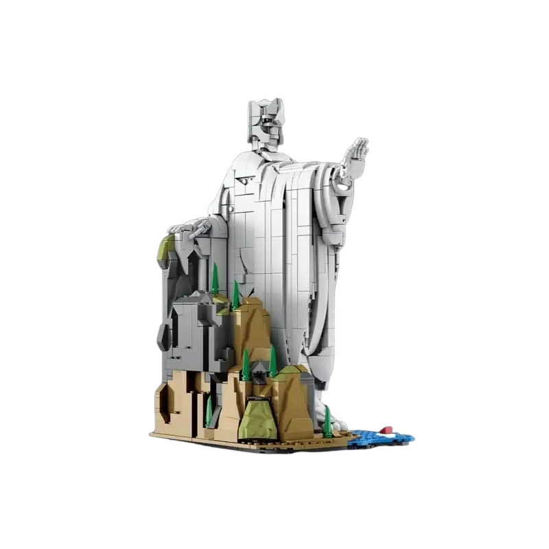A detailed white building block fantasy statue figurine of a robed figure on a rocky base with green and brown accents