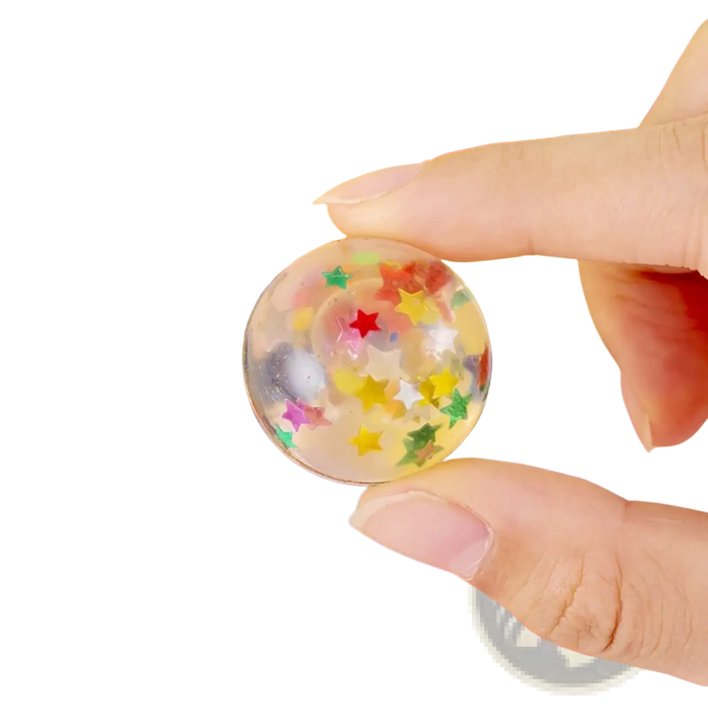 A clear round gel bulk bouncy ball filled with colorful star-shaped confetti for party favors assortment