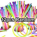 A bundle of 12 colorful neon glow sticks in pink green blue and yellow for bulk party necklaces and bracelets