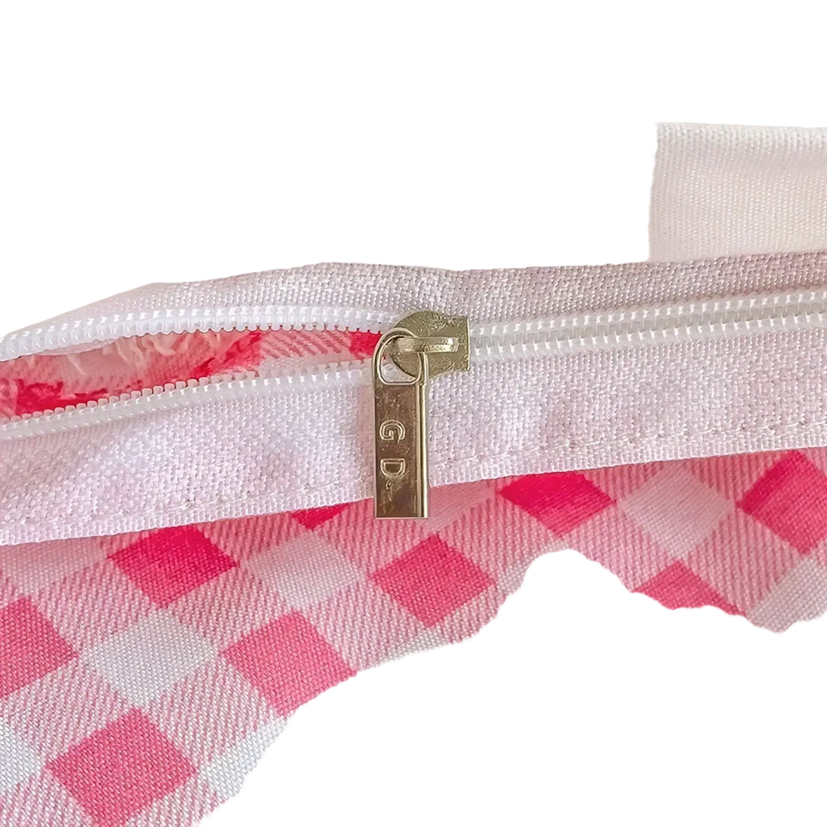 A gold-toned zipper pull with gd engraving on a white fabric zipper reveals pink gingham lining in bunny kids bedding set queen size pink sheet