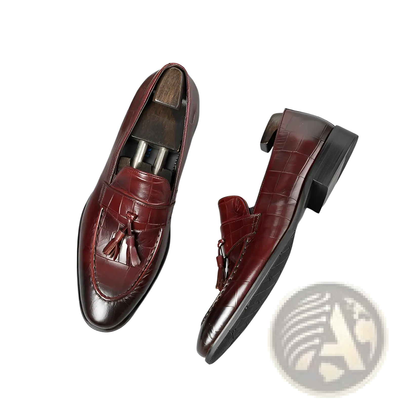Burgundy crocodile embossed leather tassel loafers with polished finish and black rubber soles shown from the back