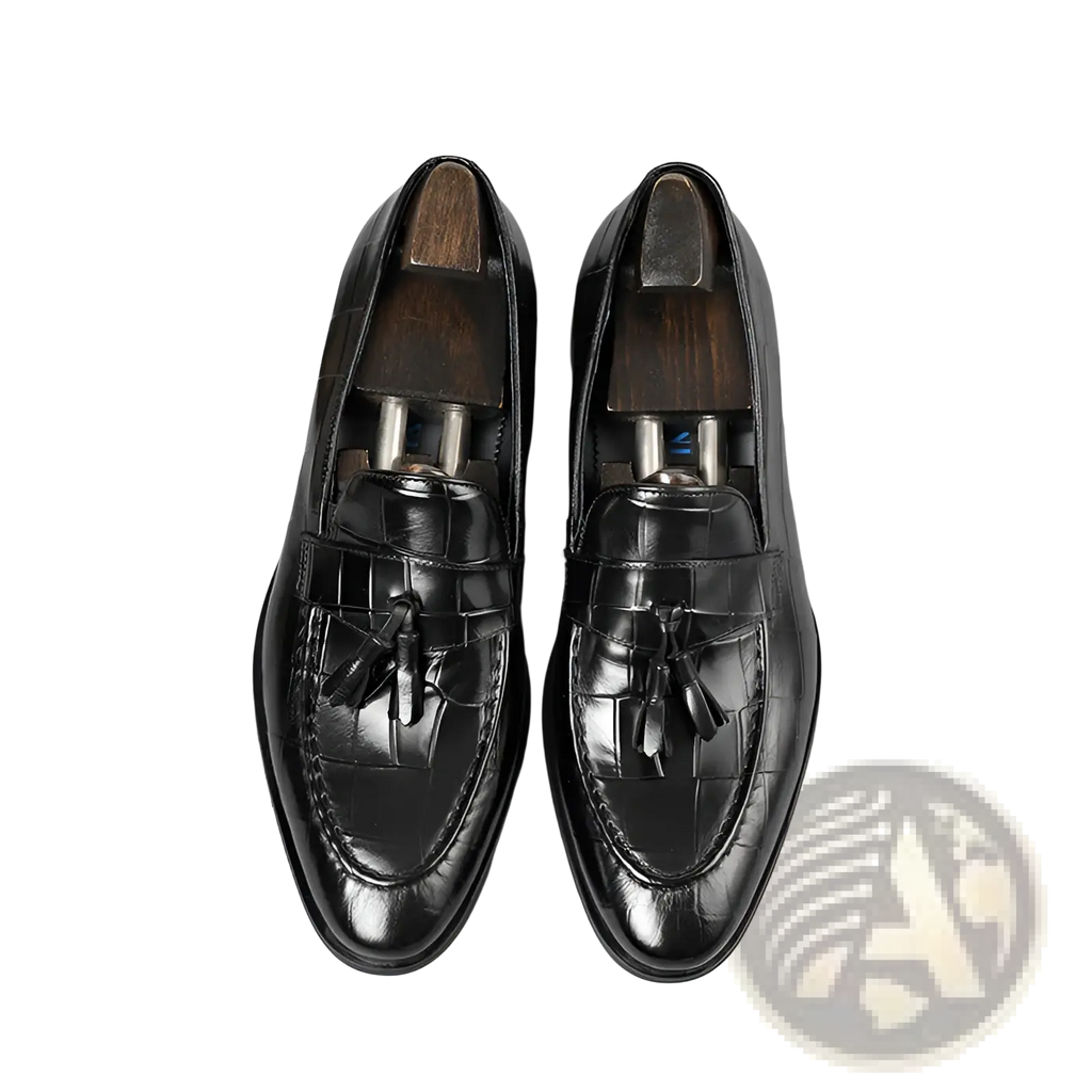 Black crocodile embossed leather tassel loafers with polished finish and classic design showing the back side