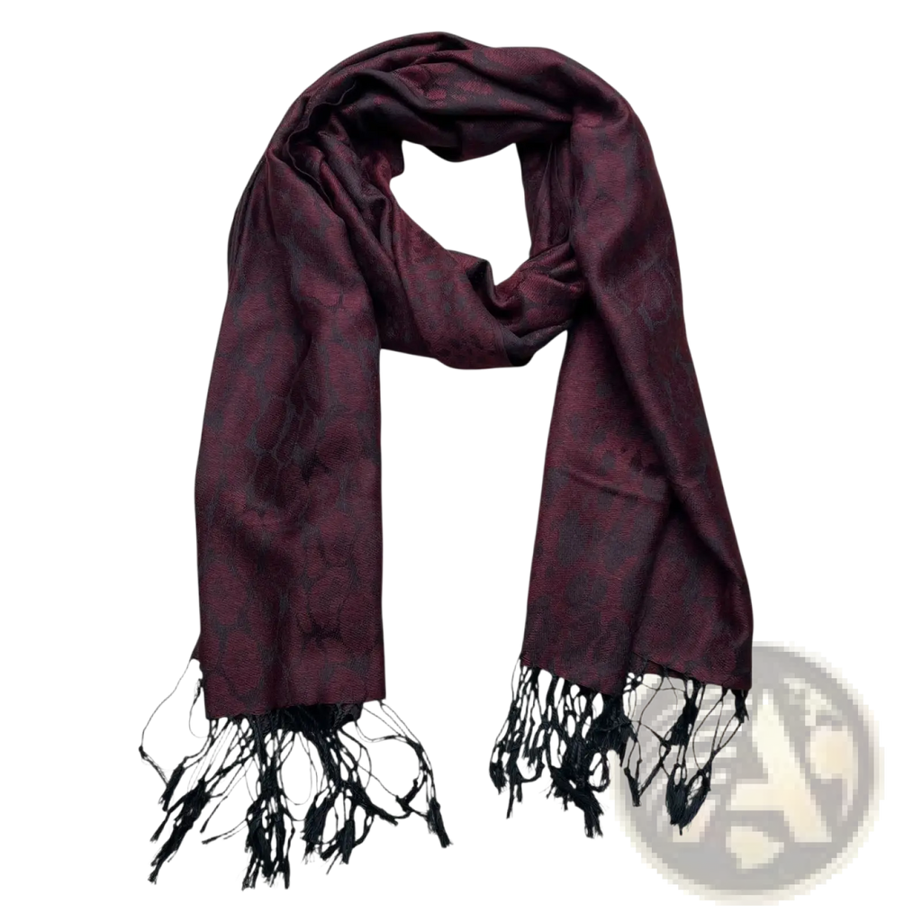 A luxurious burgundy jacquard long winter scarf with a subtle intricate pattern and black fringe detailing