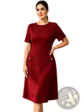 A sleek burgundy knee-length dress with short sleeves and buttoned pockets designed for formal occasions