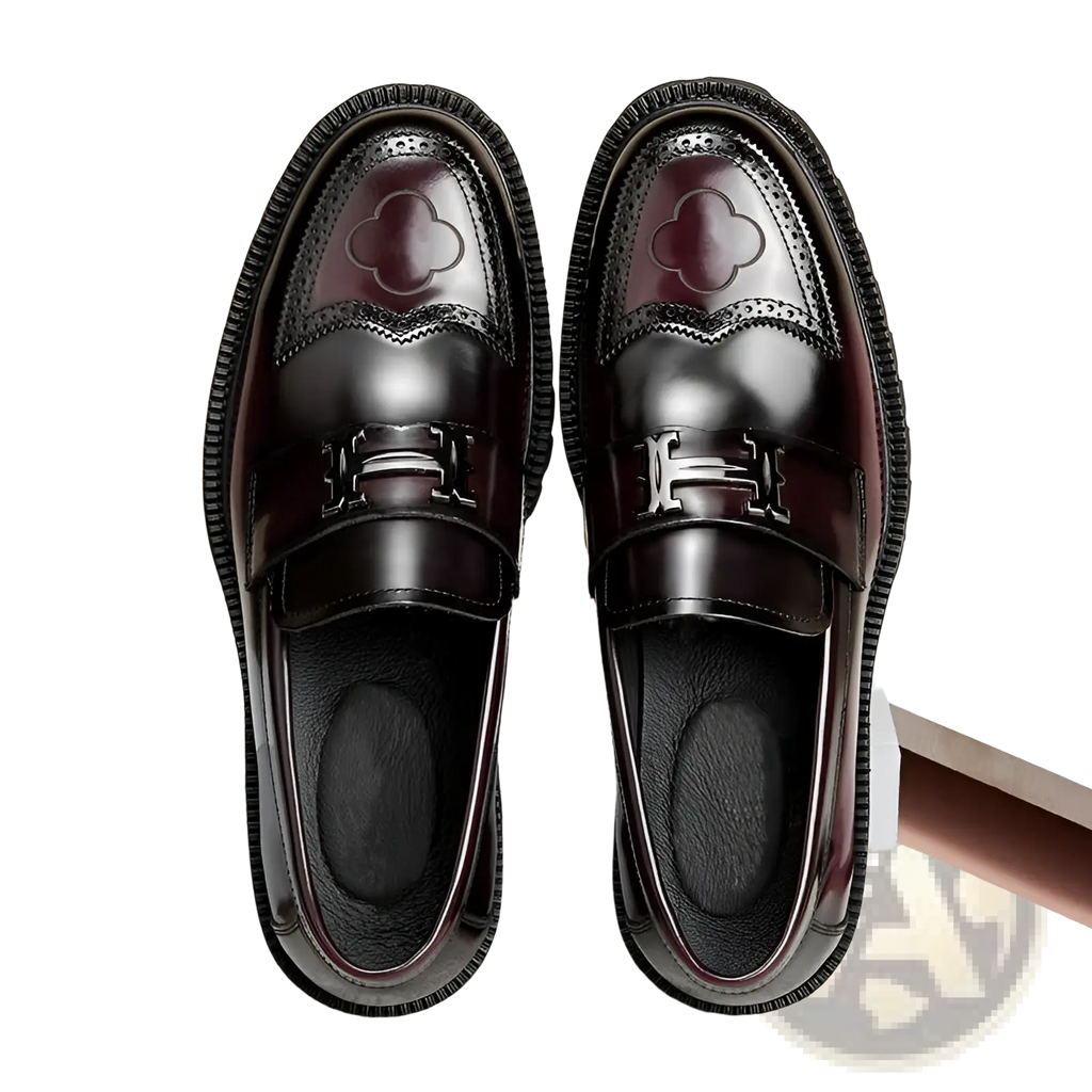 Burgundy leather loafers with glossy finish featuring embossed clover design and silver-tone h-shaped buckle