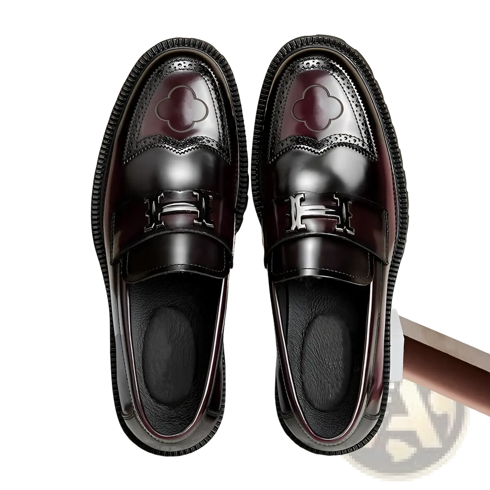 Burgundy leather loafers with glossy finish featuring embossed clover design and silver-tone h-shaped buckle