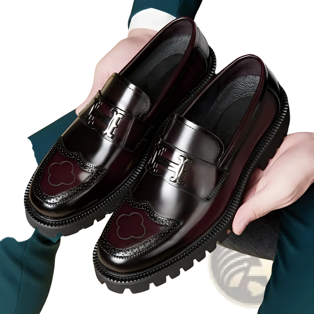 Burgundy leather loafers with rubber sole featuring a glossy finish embossed h buckle and clover-shaped brogue detailing