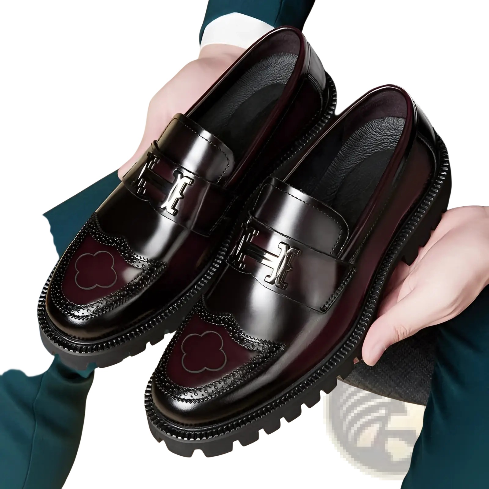 Burgundy leather loafers with rubber sole featuring a glossy finish embossed h buckle and clover-shaped brogue detailing