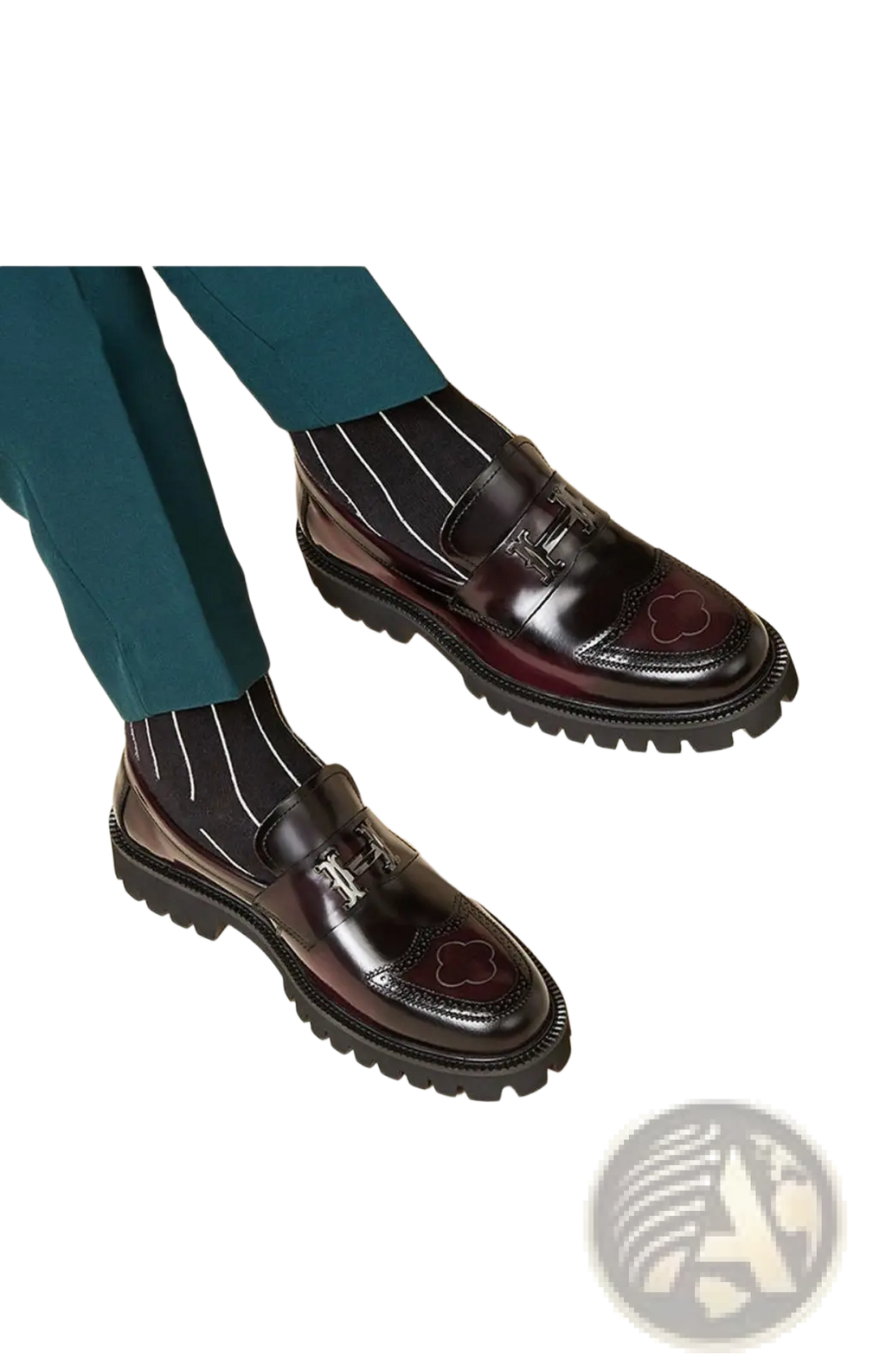 Burgundy leather loafers with buckle, polished glossy finish, decorative clover inlays, and chunky rubber sole