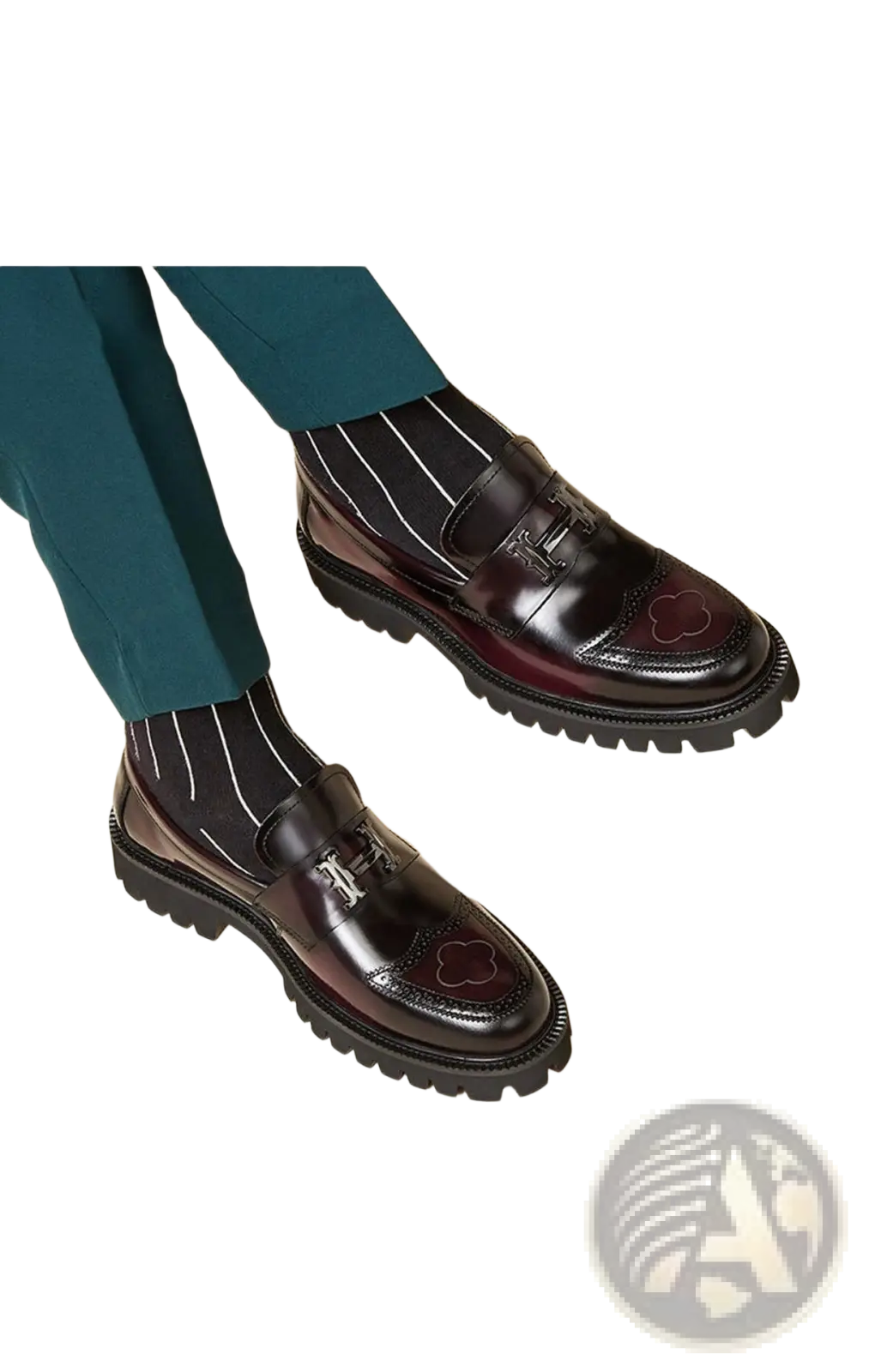 Burgundy leather loafers with buckle, polished glossy finish, decorative clover inlays, and chunky rubber sole
