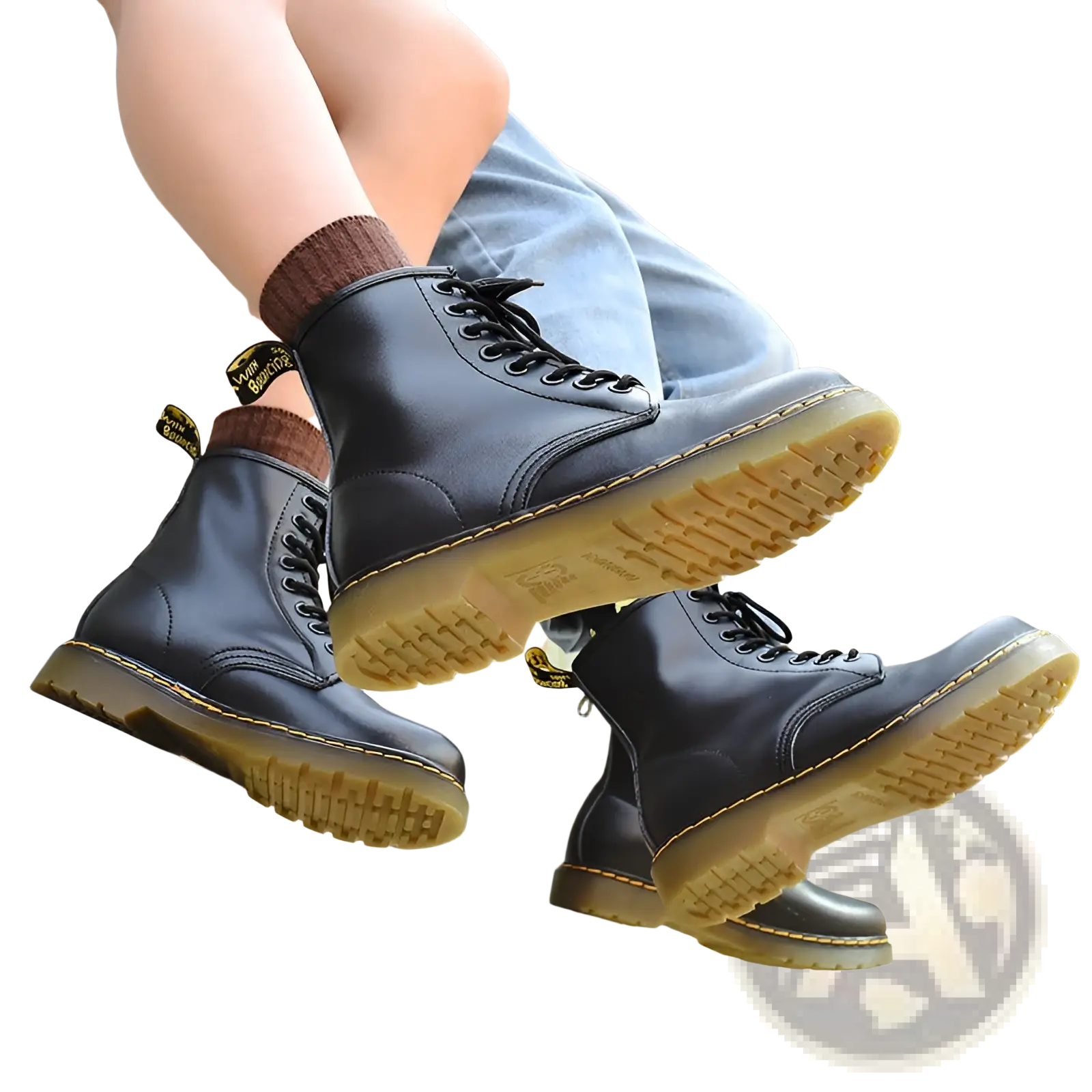 Black leather martin boots featuring yellow stitching shown from the back side