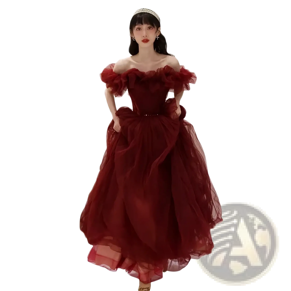 A flowing burgundy off-the-shoulder prom ball gown with a fitted bodice and voluminous tulle skirt