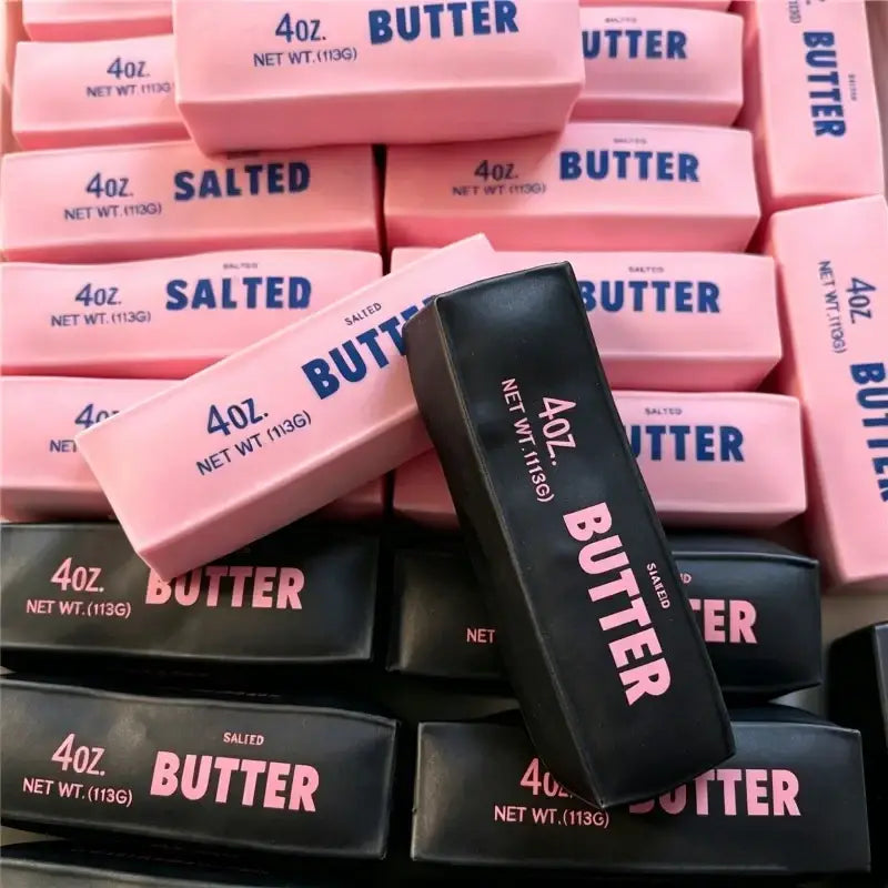 Black salted butter bar sensory squishy toy with pink lettering and matte finish for asmr play