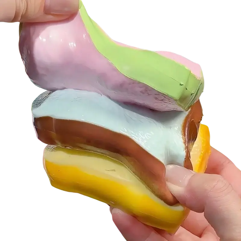 Pastel-colored layered butter stick asmr sensory squishy toy with glossy flexible surface resembling stacked pastries