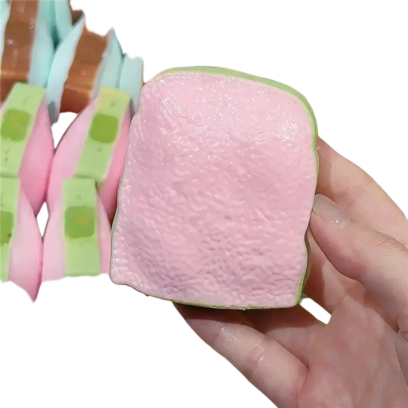 Pink and green silicone squishy toy shaped like a bread slice butter stick asmr sensory squishy toy