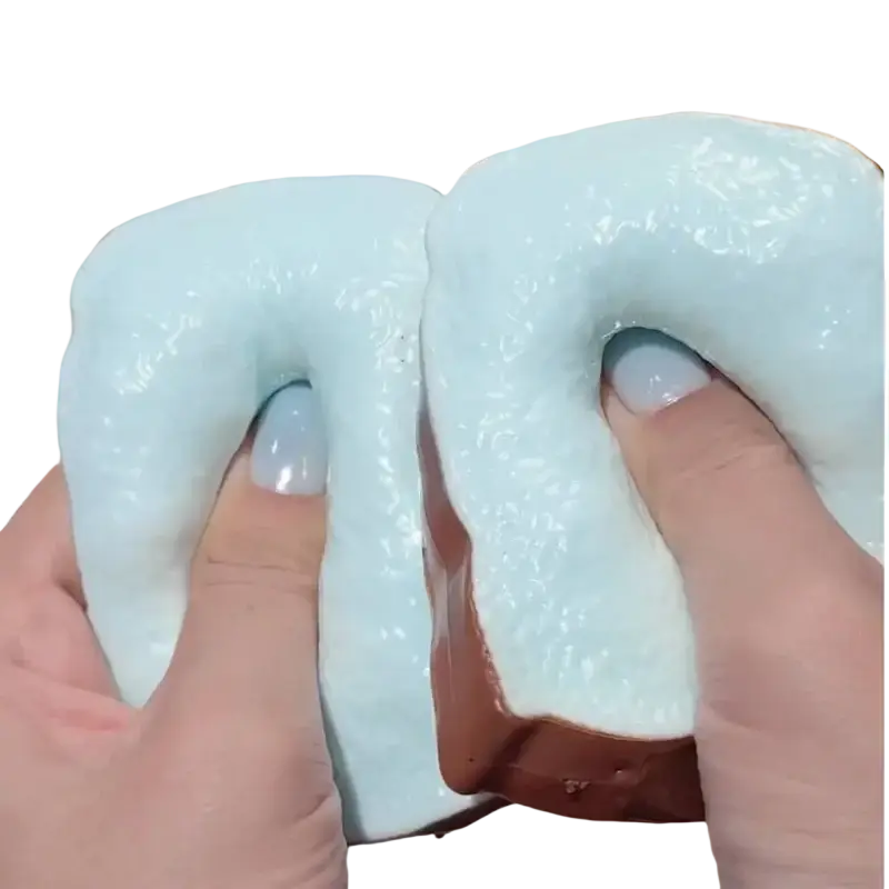 A soft light blue and brown chocolate sandwich cookie shaped butter stick asmr sensory squishy toy with glossy glaze
