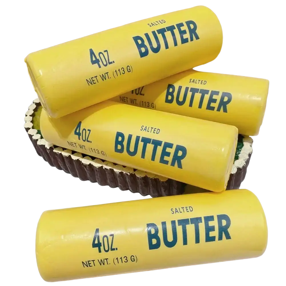 Yellow butter stick slow rising squeeze toy in glossy cylindrical packaging with bold blue lettering