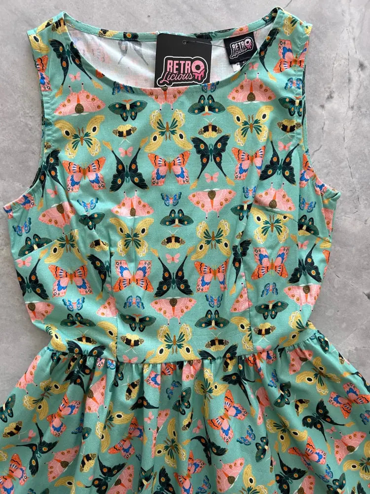 Vintage 1950s mint sleeveless cotton midi dress with vibrant colorful butterfly print in pink yellow orange and black