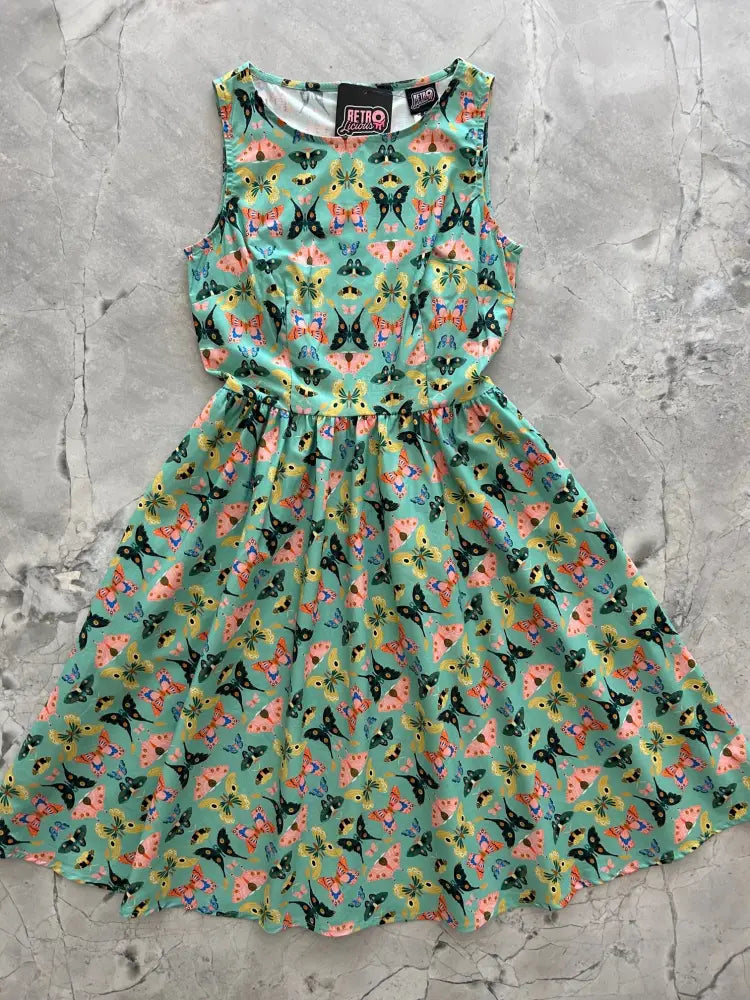 Vintage 1950s sleeveless mint green cotton midi dress with a vibrant multicolored butterfly print pattern
