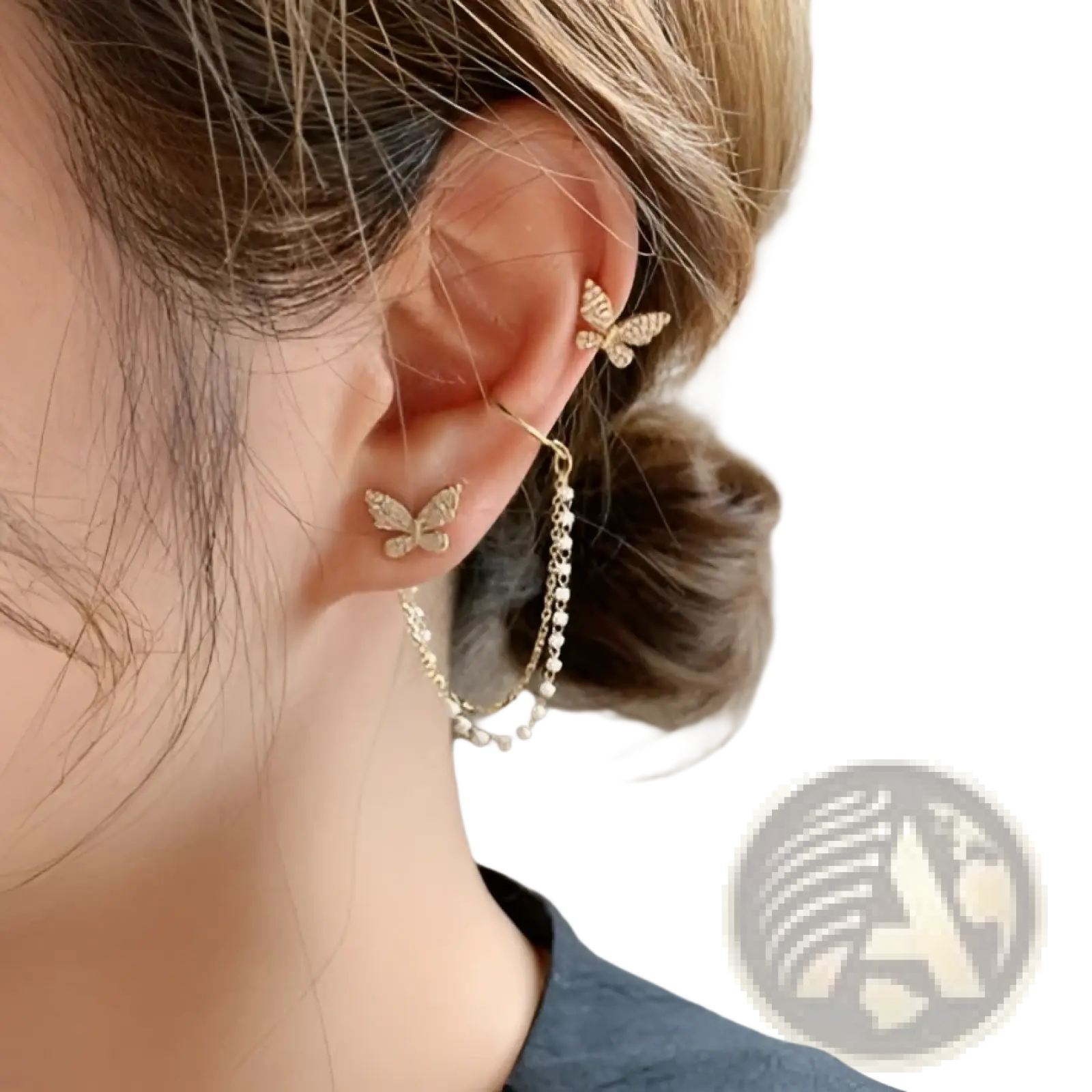 Gold-toned butterfly-shaped ear cuffs with sparkling rhinestones and a delicate pearl chain in a diamond alloy set
