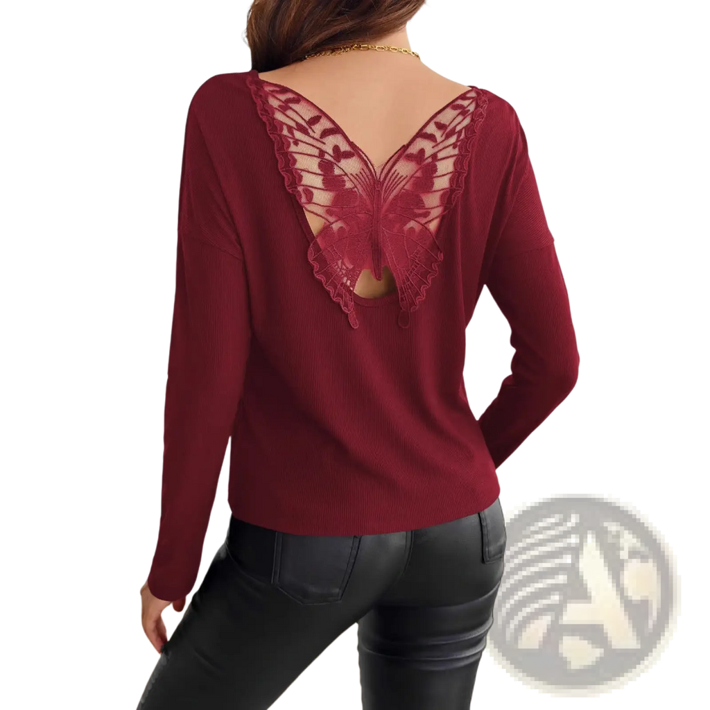 Back view of a maroon ribbed knit long sleeve top featuring an intricate butterfly-shaped lace back detail
