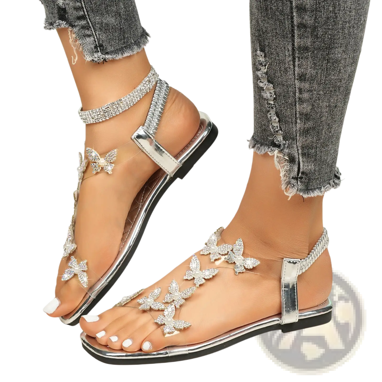 Silver butterfly rhinestone flat sandals with shiny metallic finish and crystal accents featuring square toe design