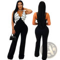 Butterfly wing slim fit jumpsuit with black and white butterfly print halter top, fitted bodice, flared pants, and thin straps