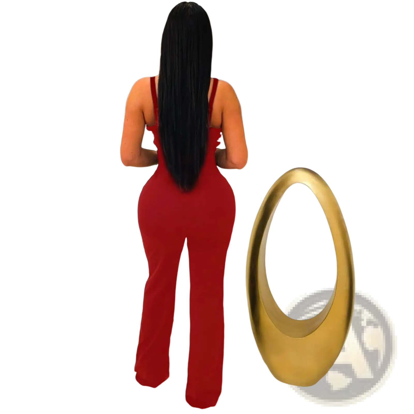 A woman shows the back side of a vibrant red butterfly wing slim fit jumpsuit with thin straps and flared legs