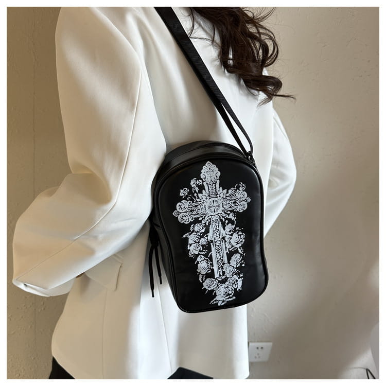 Black cross-themed mini shoulder bag featuring white floral and ornate embroidered detailing for Halloween use.