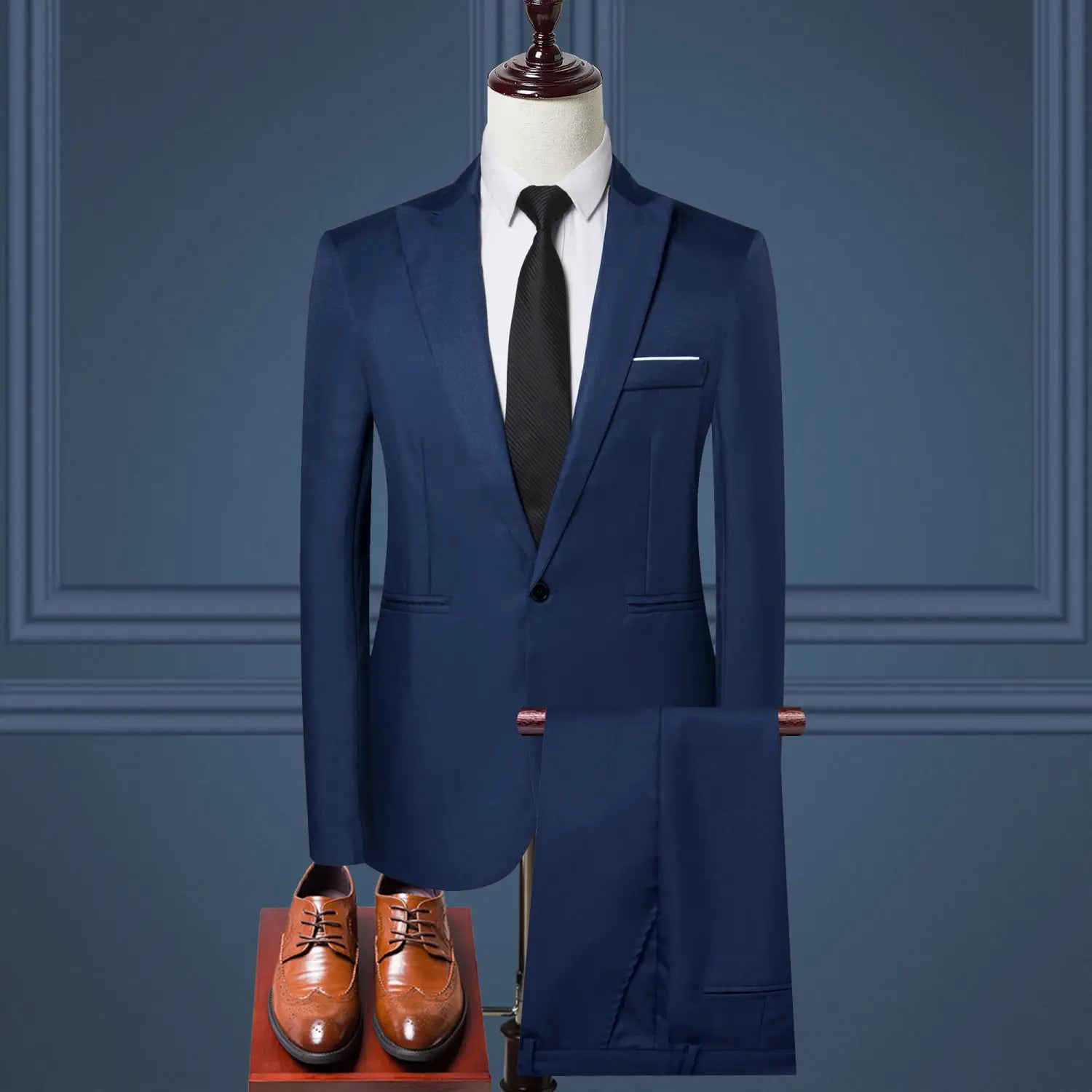 Navy blue tailored men solid color two piece leisure suit displayed on a mannequin with matching trousers and brown leather dress shoes.