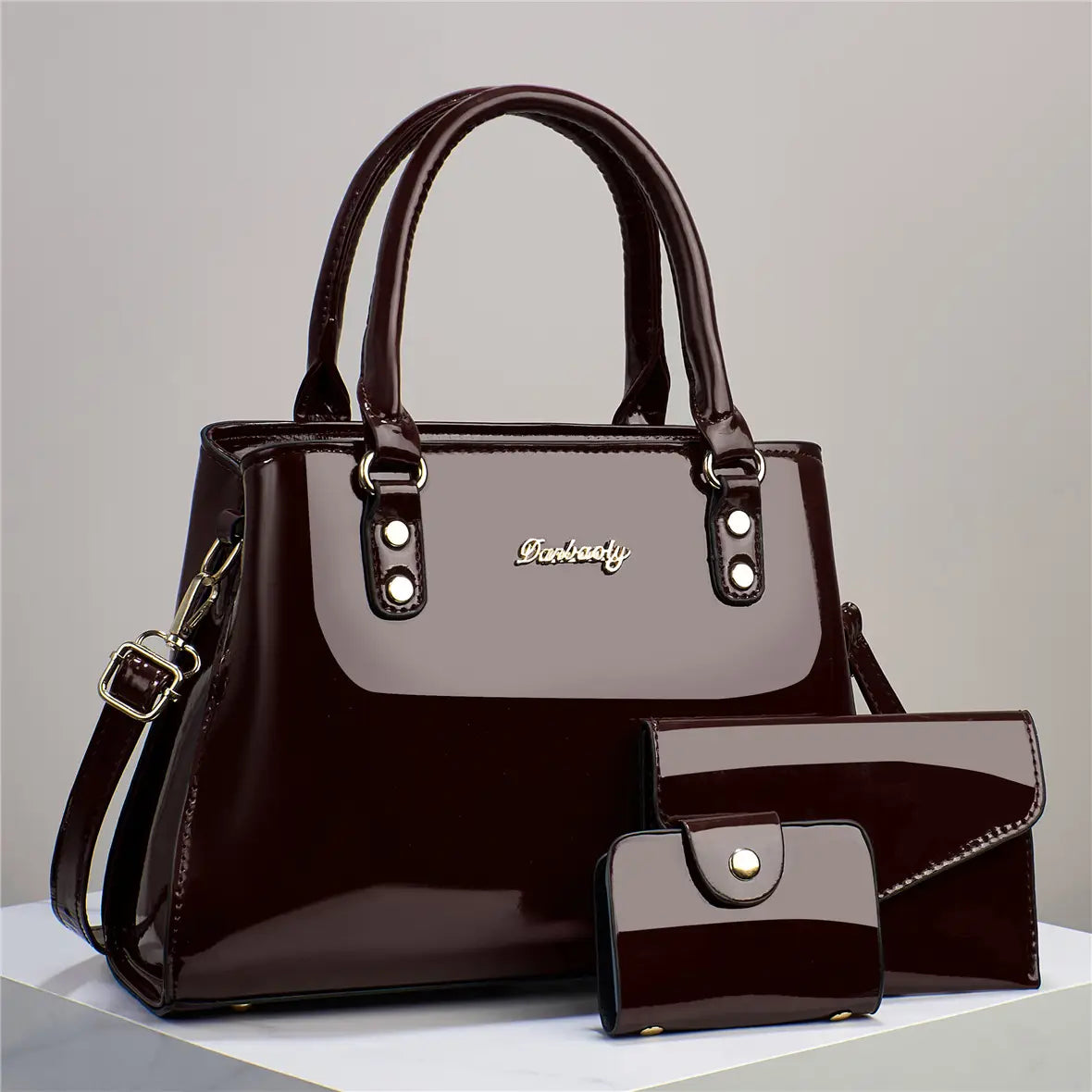 Shiny dark brown patent leather 3-piece handbag and wallet set with gold-tone hardware including a handbag, wallet, and clutch.