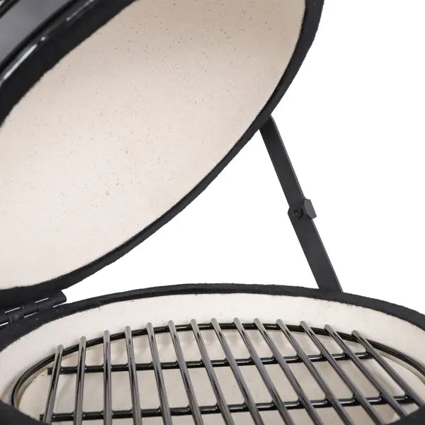 Black ceramic 13 inch kamado charcoal grill with a white ceramic interior and metal grates.