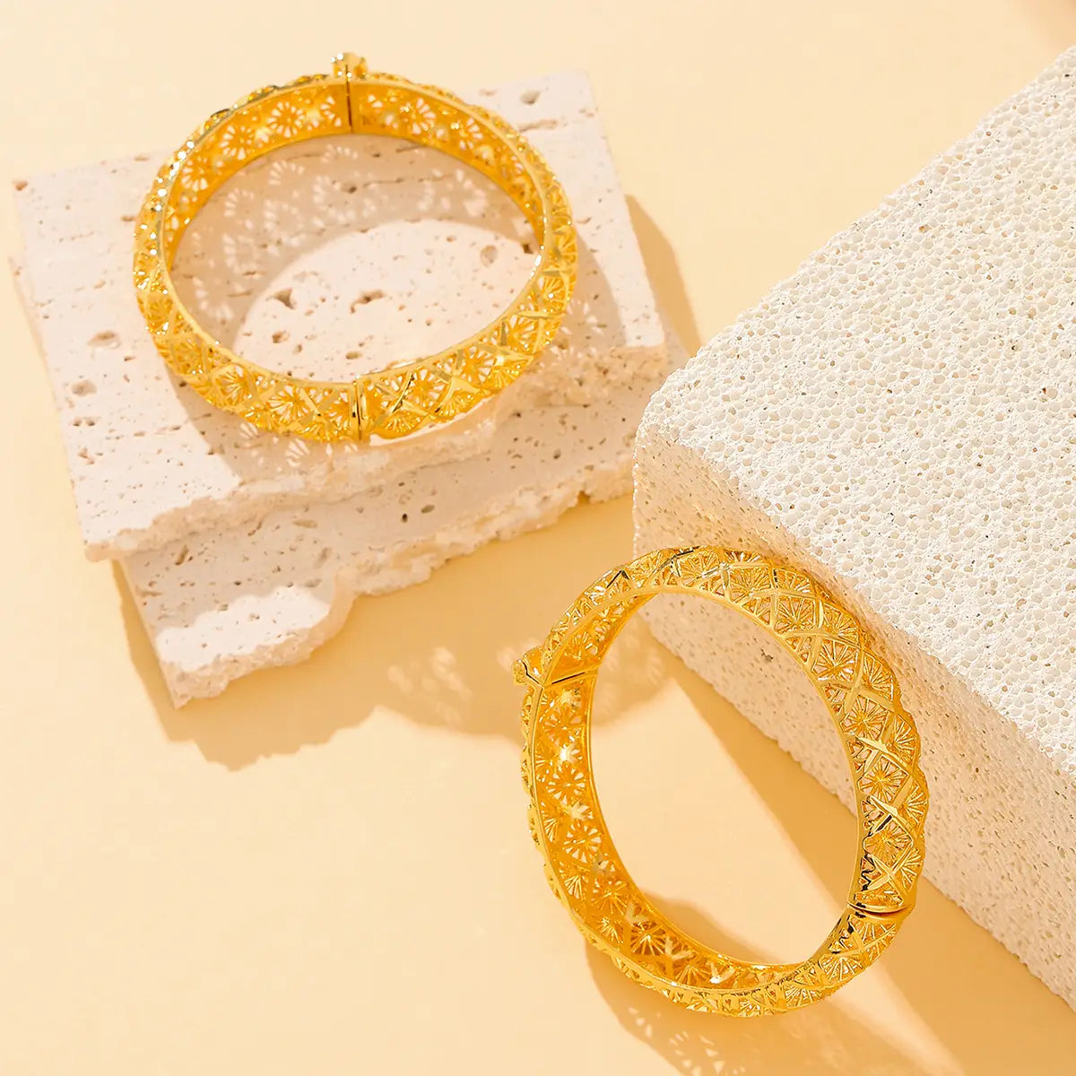 Vintage 18k gold plated filigree four leaf clover bangle bracelets with intricate gold patterns.