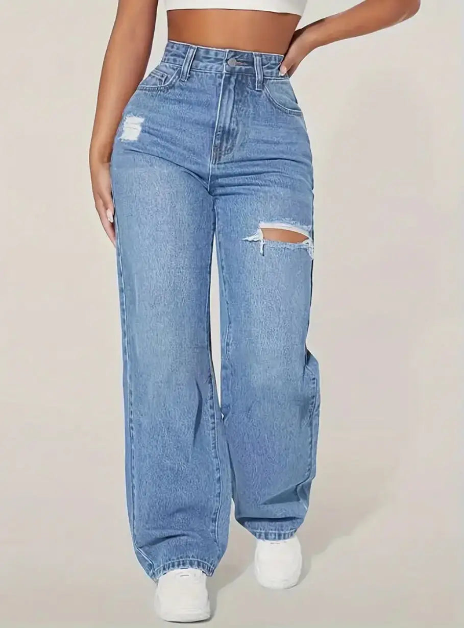 distressed high rise wide leg denim jeans in light-wash material featuring ripped details on the thighs.