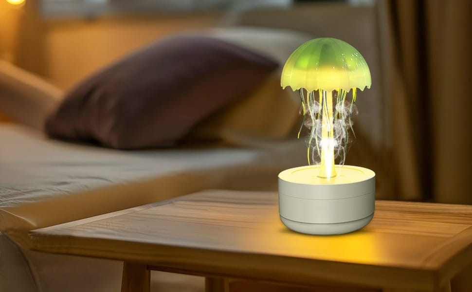 A glowing green jellyfish-shaped nightlight humidifier with a white base designed to emit soft ambient light and diffuse essential oils using 7 color LED.