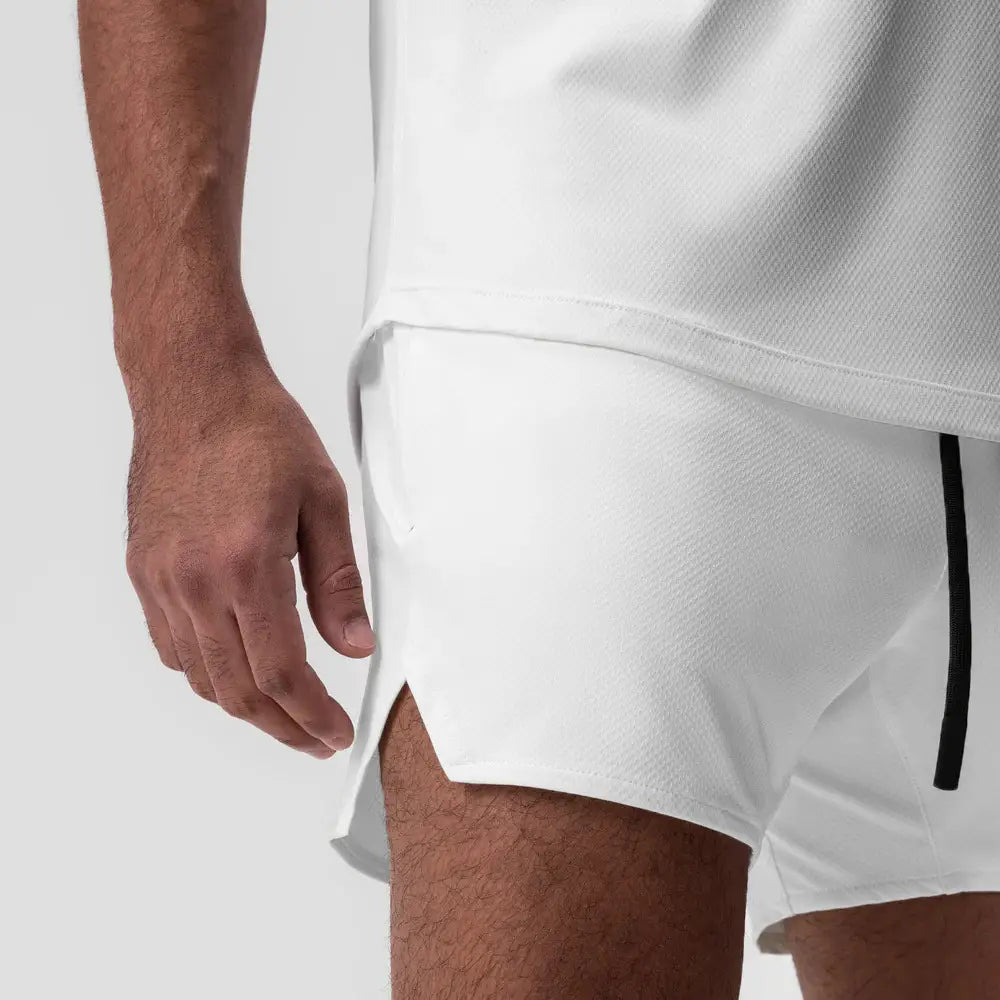Men quick dry athletic sports shorts in white textured fabric featuring a black zipper detail on the side.