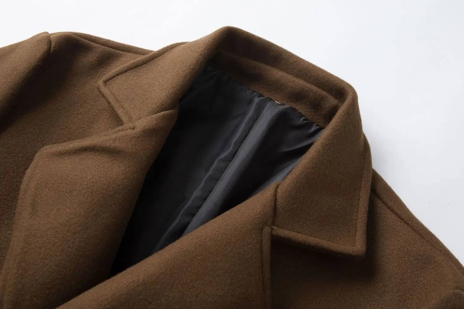 Men double breasted mid length wool overcoat in brown with a structured collar and black lining.