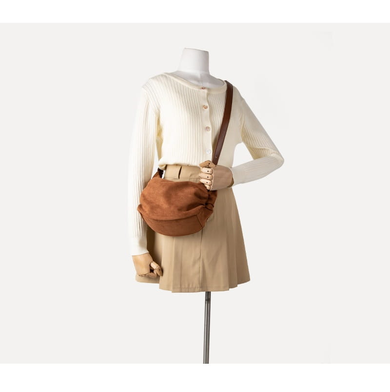 brown leather suede dumpling shoulder bag with a soft rounded shape and adjustable crossbody strap for slouchy hobo style use