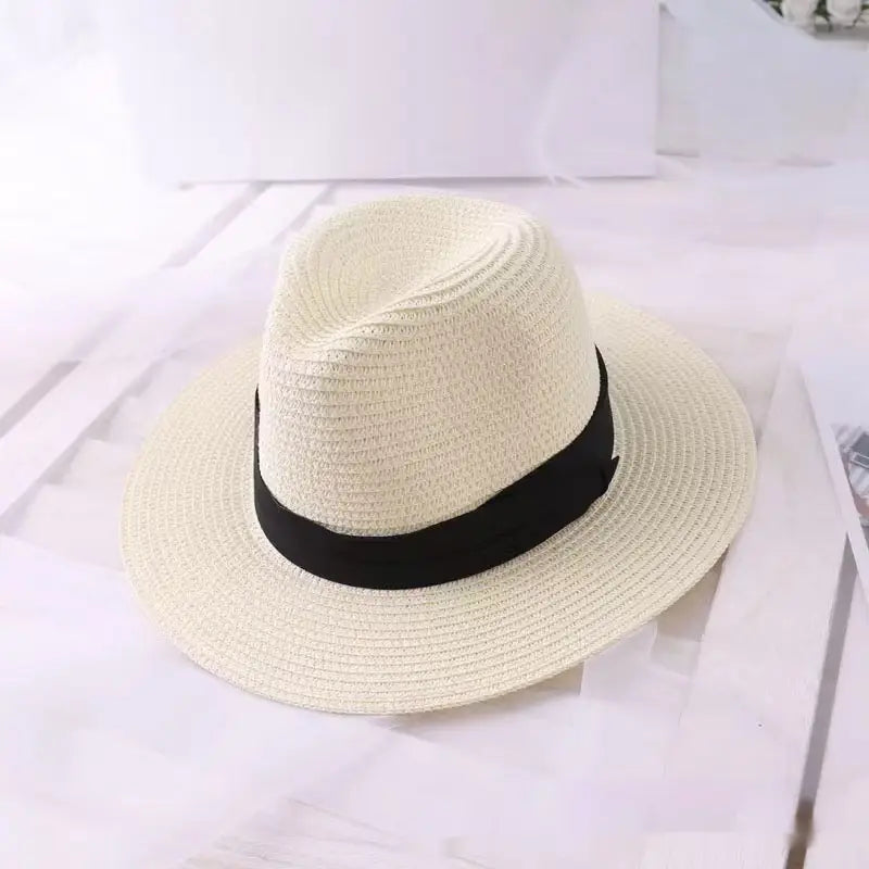 Beige uv proof straw fedora hat for men with a black ribbon band and classic design.
